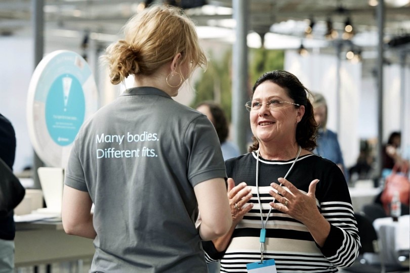 picture of a Coloplast employee talking to a woman